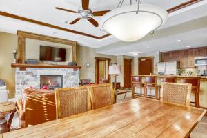 a dining room with a table and a fireplace at Northstar Village #410 in Kingswood Estates