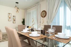 uma sala de jantar com mesa e cadeiras e um relógio em HiGuests - Dazzling Apt With Panoramic View Near Burj Khalifa em Dubai