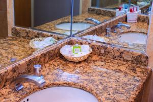 a row of sinks in a bathroom with mirrors at Hotel Revolución in Mexico City