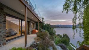 a house with a view of a lake at Kohanga Luxury Lakeside Villa by Amazing Accom in Queenstown