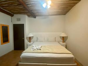 Un dormitorio con una cama blanca con dos lámparas. en Casa CARIBE Cancun, en Cancún 195 fotos más