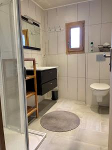 a bathroom with a sink and a toilet at Gîte avec terrasse et belle vue - ChaletNelda com in Lamoura