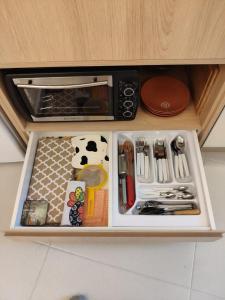 a drawer filled with utensils in a cabinet at Flat Prédio Frente MAR Garagem Piscina Academia Portaria 24 h in Balneário Camboriú +32 photos