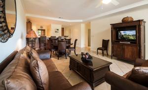a living room with a couch and a dining room at Ocean View Condo in Los Sueños in Herradura