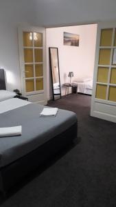 una camera d'albergo con letto e specchio di Chambres d'Hotes Centre Ville a Agen