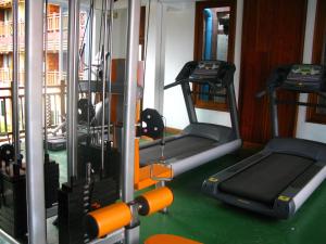 a gym with two treadmills and two machines at Chanthapanya Hotel in Vientiane