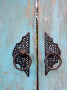 two metal handles on a blue door at RNV Eco Resort Bungalows in Batukaras