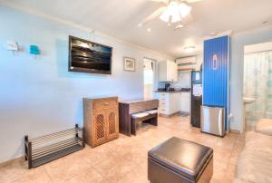 a living room with a table and a kitchen at Tropic Terrace #51 - Beachfront Rental condo in St. Pete Beach
