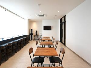 a row of tables and chairs in a room at Hotel Trend Suzuka in Suzuka