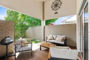an outdoor patio with a couch and a table at Frewville 7 Apartment in Mount Gambier