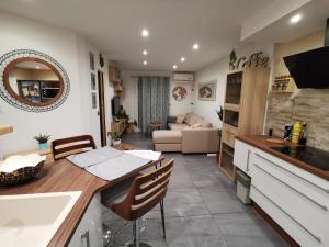 a kitchen and living room with a table and a sink at La Terrasse Ensoleillée de Sausset - Côte Bleue in Sausset-les-Pins