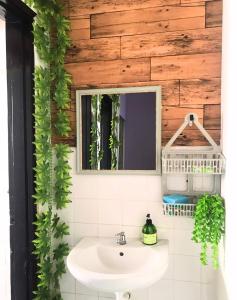 a bathroom with a sink and a mirror at Lavender@Guesthouse in Malacca