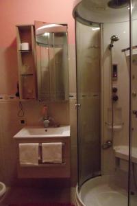 a bathroom with a shower and a sink at Hotel Total in Pisogne