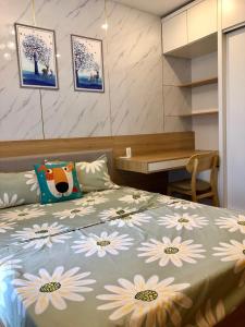 a bedroom with a bed with flowers on it at SHP Plaza Khanh Phong Homestay in Hai Phong