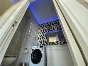 a washer and dryer in a bathroom with a ceiling at ЖК ‘ZAMAN’ in Atyrau