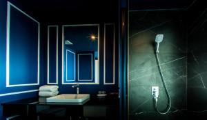a bathroom with a sink, toilet and mirror at Krabi Tipa Resort - SHA EXTRA PLUS in Ao Nang Beach