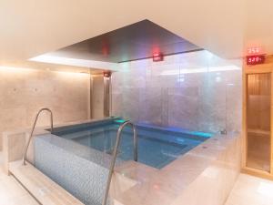 a large swimming pool in a room with at The Howard Prince Hotel Taichung in Taichung