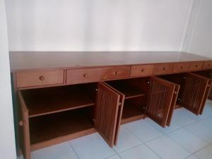 a wooden desk with a wooden top and shelves at Villa Mahalini Seminyak in Seminyak