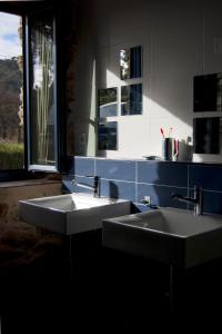 two sinks in a bathroom with a window at Pedracuca - Costa da Morte in Neaño +60 photos