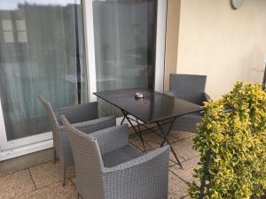 a table and chairs on a balcony with a window at Aparthotel Des 2 Caps in Ambleteuse +109 photos