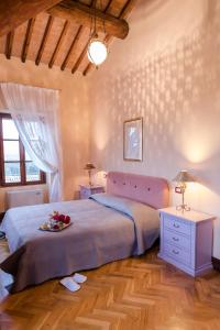 a bedroom with a bed with a tray of food on it at B&B Villa Nichesola in Colognola ai Colli