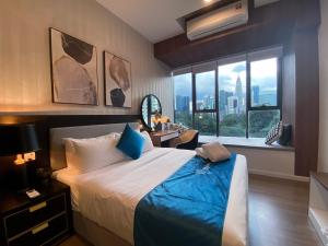 a bedroom with a large bed and a large window at Ceylonz Lifestyle Suites @ Bukit Bintang in Kuala Lumpur