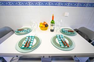 a table with plates and a bottle of wine at LAS COLUMNAS in Port de Pollensa