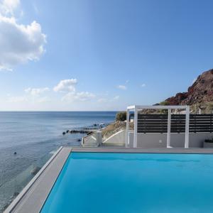 a swimming pool with a view of the ocean at Sublime Villa & Caves in Akrotiri