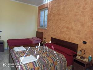 a bedroom with two beds and a window at Dolcedorme del Pollino in Morano Calabro