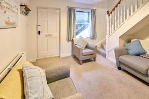 a living room with a couch and two chairs at Host & Stay - Richemont Cottage in Whitby