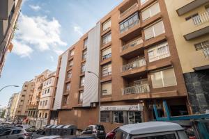a row of buildings on a city street with cars at Casa Tiago in Santa Cruz de Tenerife