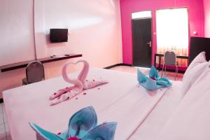 Postel nebo postele na pokoji v ubytování Hotel FX72 Ruteng