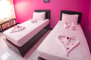 Postel nebo postele na pokoji v ubytování Hotel FX72 Ruteng