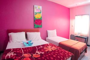 Postel nebo postele na pokoji v ubytování Hotel FX72 Ruteng