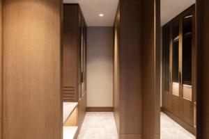 a hallway with wooden cabinets and a walk in closet at NG Enjoy in Sapanca