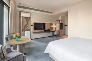 a hotel room with a bed and a table at Address Beach Resort in Dubai