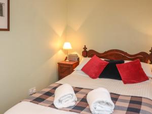 1 dormitorio con 2 camas y almohadas rojas y blancas en 33 Island Street en Salcombe