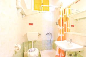 a small bathroom with a toilet and a sink at Villa Kefalaki in Katávolos +48 photos