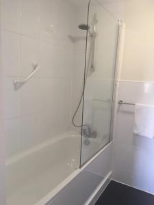
a bathroom with a shower stall with a glass shower door at OYO The Old Lodge in Gosport

