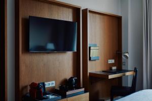 a hotel room with a flat screen tv on a wall at Gallery Hotel in Barcelona