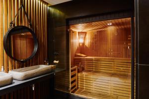 a bathroom with a tub and a sink and a mirror at Catalonia Boulevard 4 Sup in Barcelona