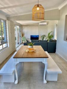 a living room with a table and a couch at Surf Motel in Umdloti