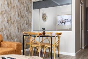 a dining room with a table and chairs at Menlyn Marble Print Apartment in Pretoria