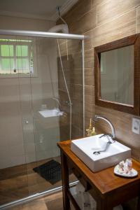 a bathroom with a sink and a shower at Hotel Pousada do Conde in Canela +68 photos