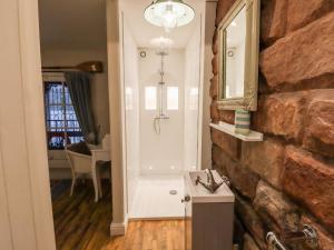 a bathroom with a sink and a mirror on a wall at Horton Lodge Boathouse in Leek +13 photos