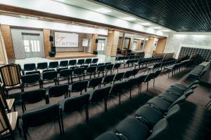 an empty lecture hall with chairs and a stage at Hotel BUTTERFLY in Sadove +50 photos