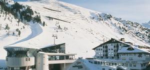 a ski resort with a snow covered mountain in the background at Hotel Sportiv by VAYA in Obergurgl