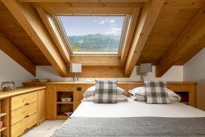 
a bedroom with a bed and a window at Miramonti Park Hotel in Bormio
