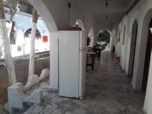 an empty hallway with a white refrigerator in a building at Fighting Kangaroo Camp in Dahab