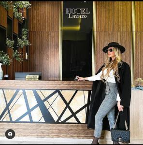 a woman wearing a hat and a black coat at Hotel Lazaro in Podgorica
